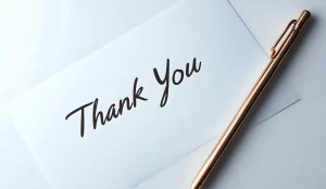 Thank you card with a gold pen.